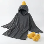Silly Goose PJs black wearable blanket flat lay with slippers What comes with Silly Goose PJs? Black goose hooded wearable blanket and matching yellow goose slippers flat lay.