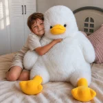 Freddie the Duck Plushy with child Child hugging the oversized Freddie the Duck Plushy